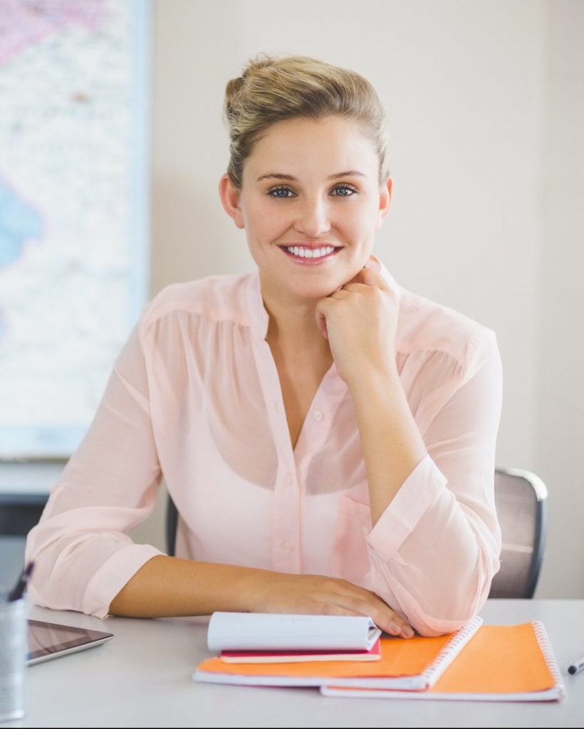 Teacher sitting in classroom Teacher sitting in classroom